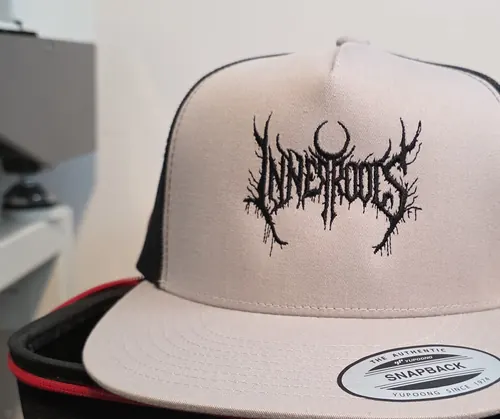 Silver and black Yupoong 5-panel trucker with the black Inner Roots logo