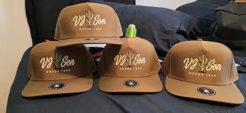 Four tan caps embroidered with the VJ Son Desde 1942 logo