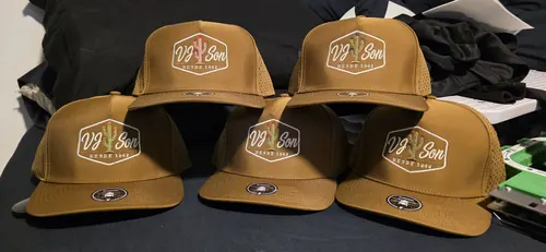 Five tan caps lined up, each embroidered with the VJ Son Desde 1942 hexagon logo with a cactus